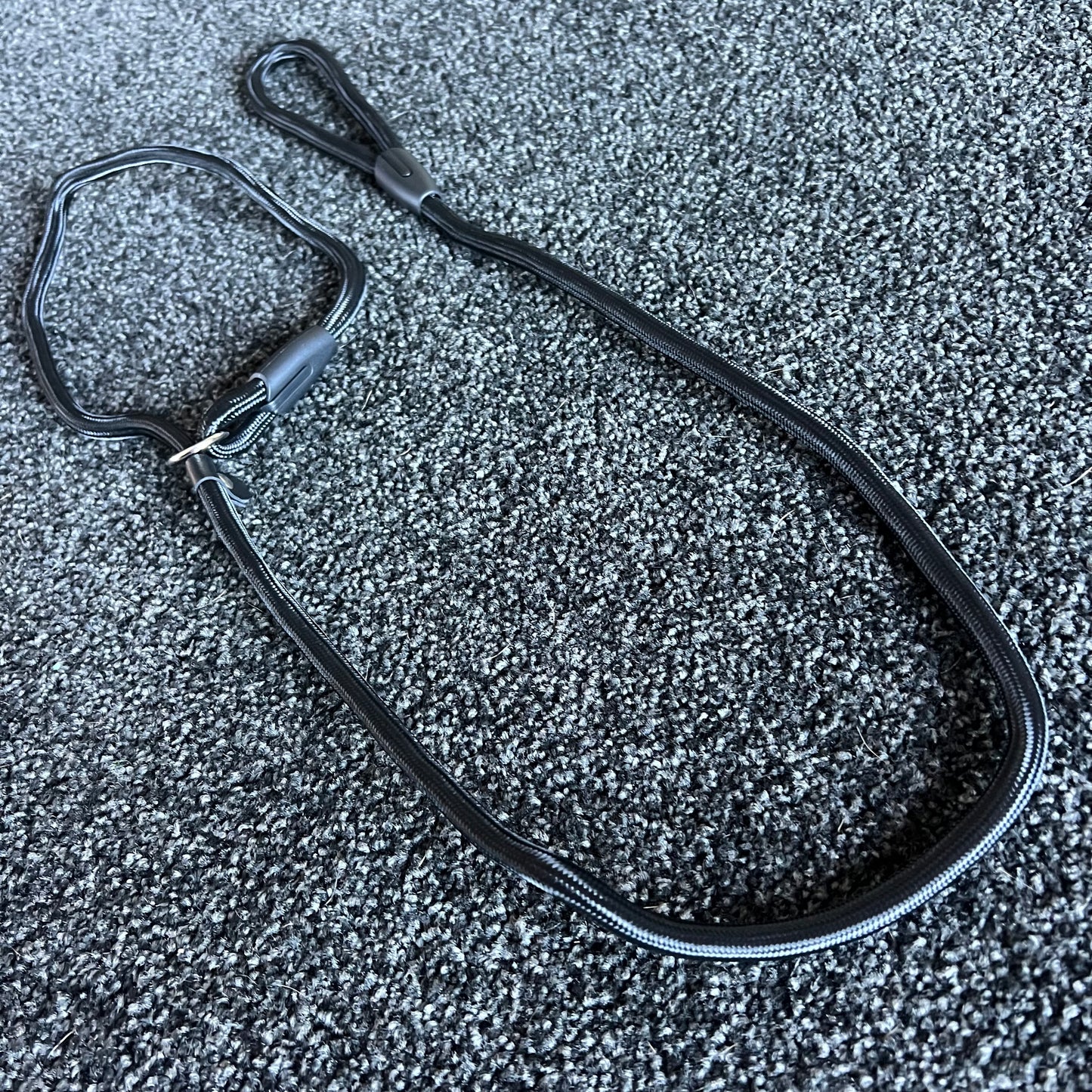 Black Slip Leash on a textured gray surface