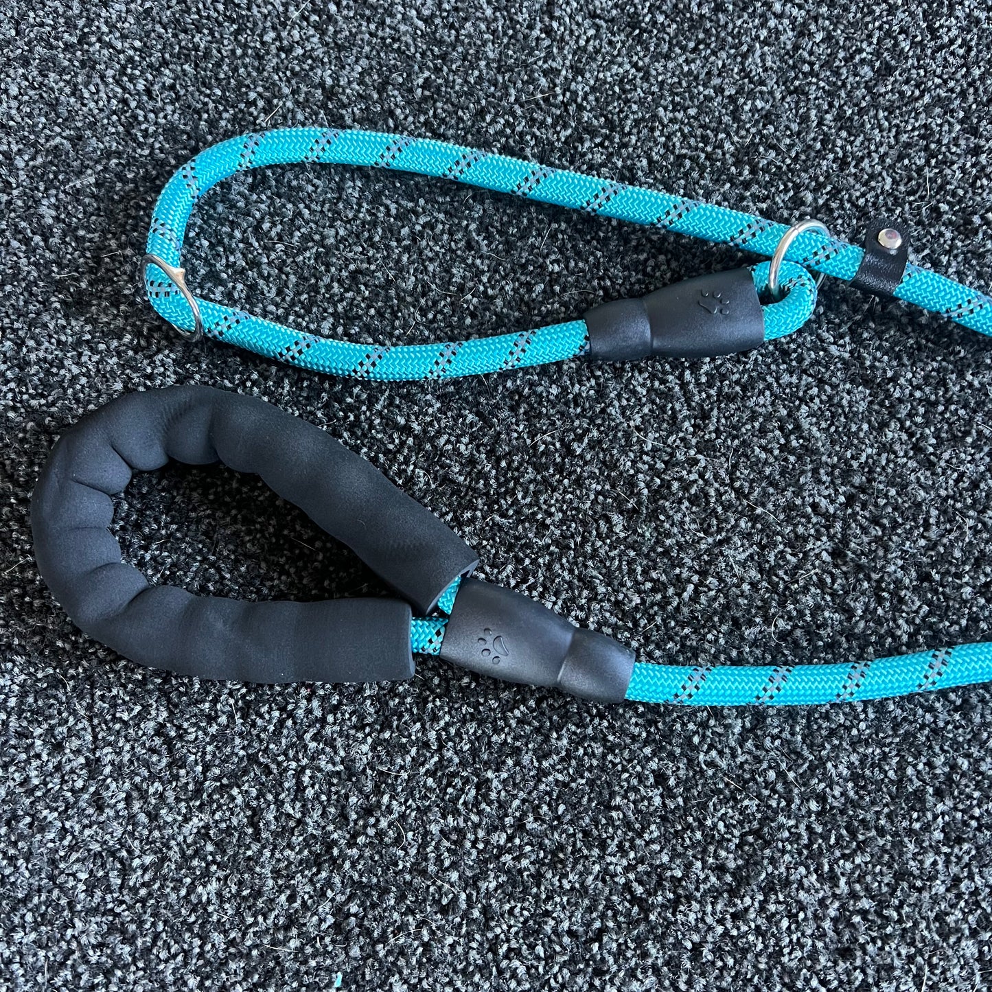 Blue and black dog leash on a textured surface