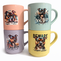 Four mugs with Staffordshire Bull Terrier illustrations and text on a white background