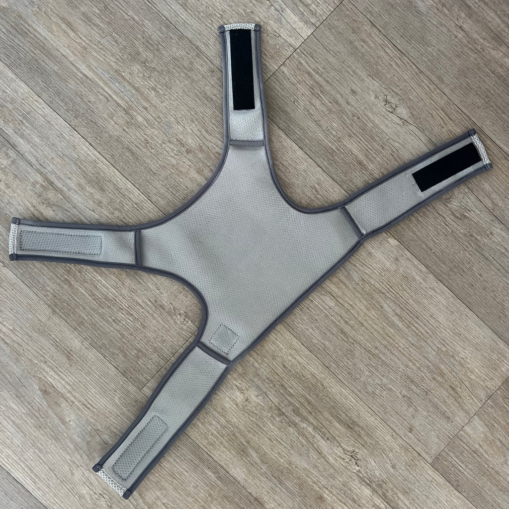 Grey cooling vest on a wooden floor