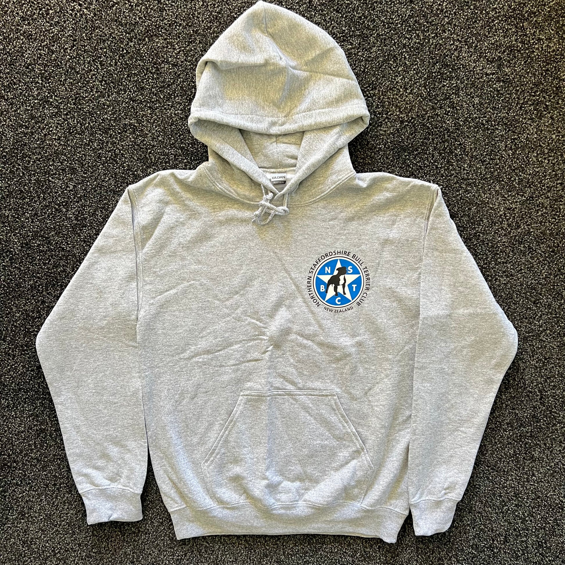 Gray hoodie with a logo on a dark textured surface