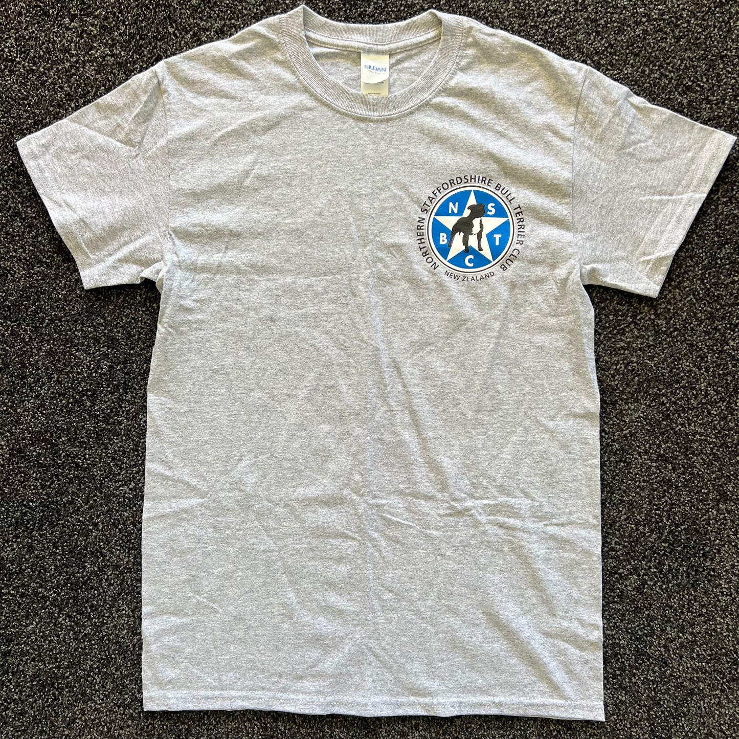 Gray t-shirt with a logo on a black textured background