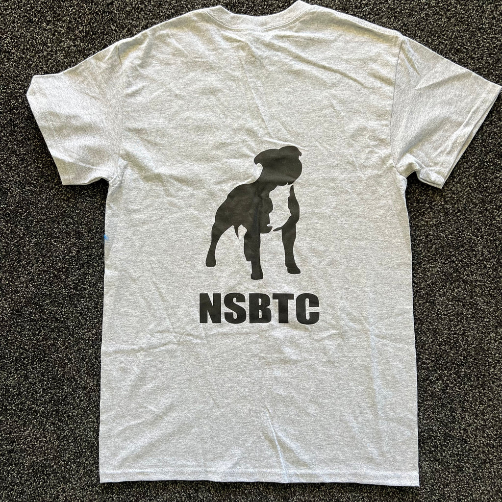 White t-shirt with black dog silhouette and 'NSBTC' text on a dark textured background