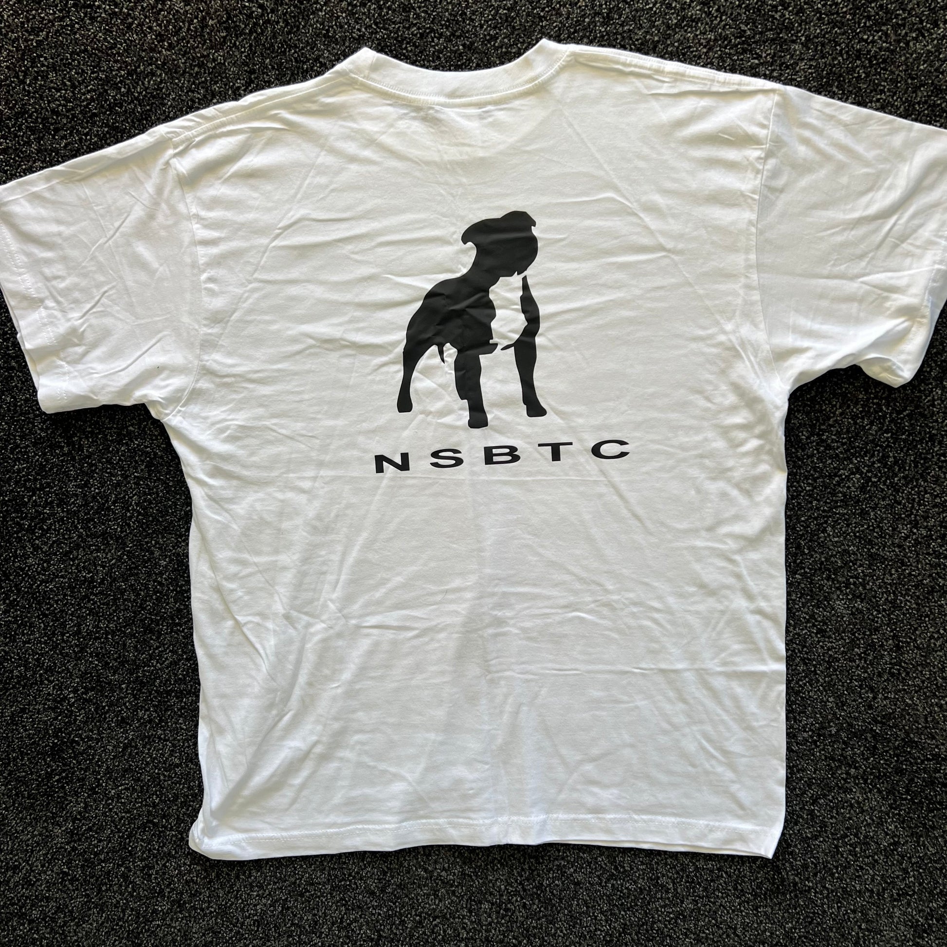 White t-shirt with black silhouette graphic and 'NSBTC' text on a dark background