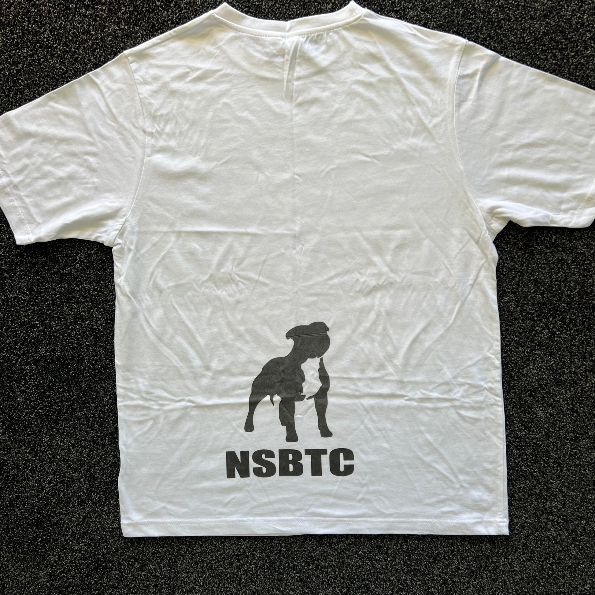 White t-shirt with a black silhouette and 'NSBTC' text on a dark textured background